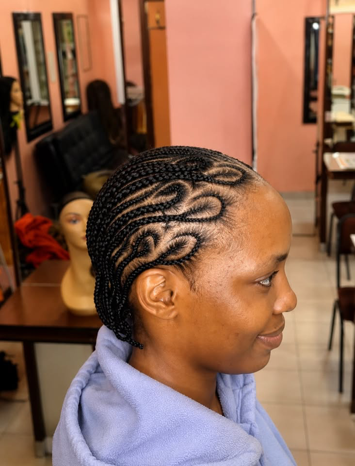 Intricate freestyle cornrow design, side view